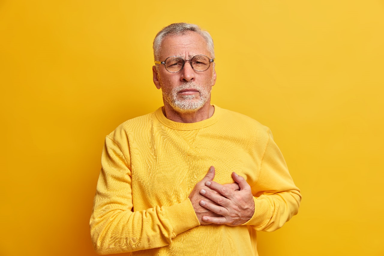 Which Ayurvedic tonic should be taken to reduce cholesterol naturally?